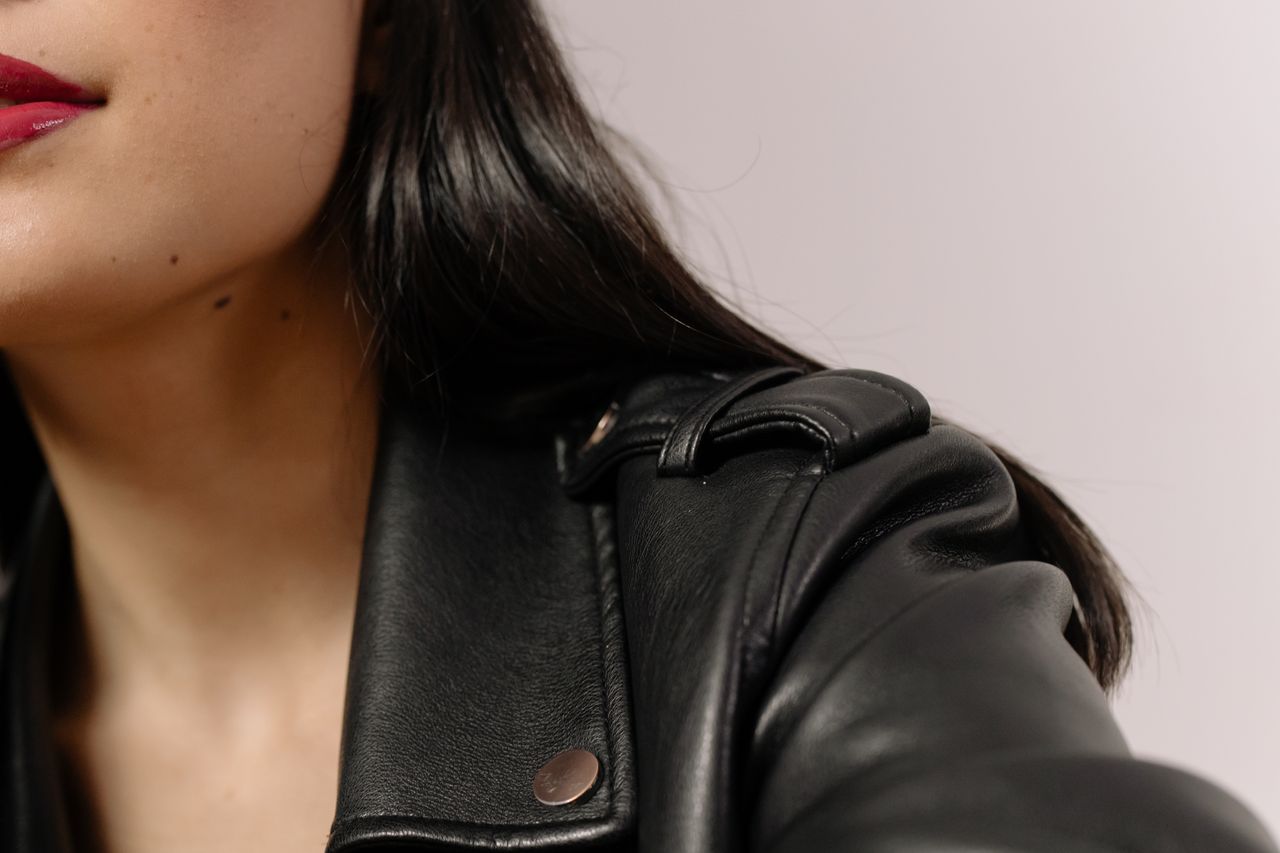 Crafting Captivating Headlines: Your awesome post title goes here Detailed close-up of a woman with red lipstick and black leather jacket, showcasing style and elegance.
